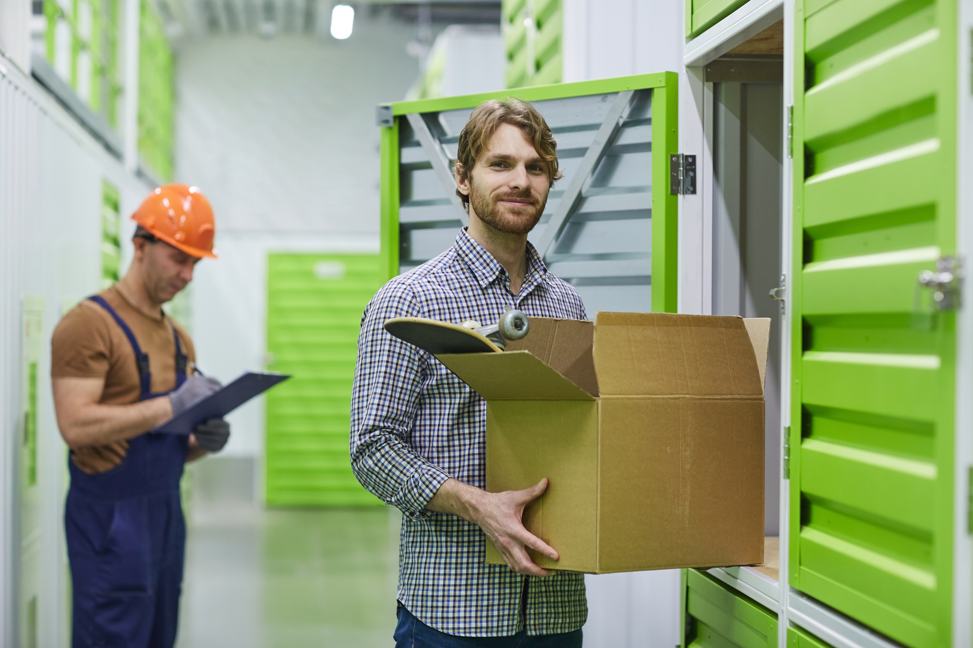 Man putting things in storage boxes